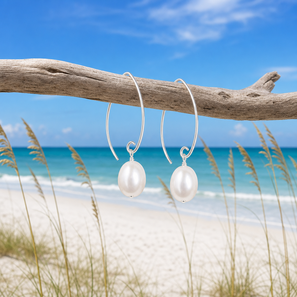 Pearl marquise sterling silver earrings with freshwater pearl hanging from driftwood on Florida Gulf Coast beach &mdash; Crabby Mermaid