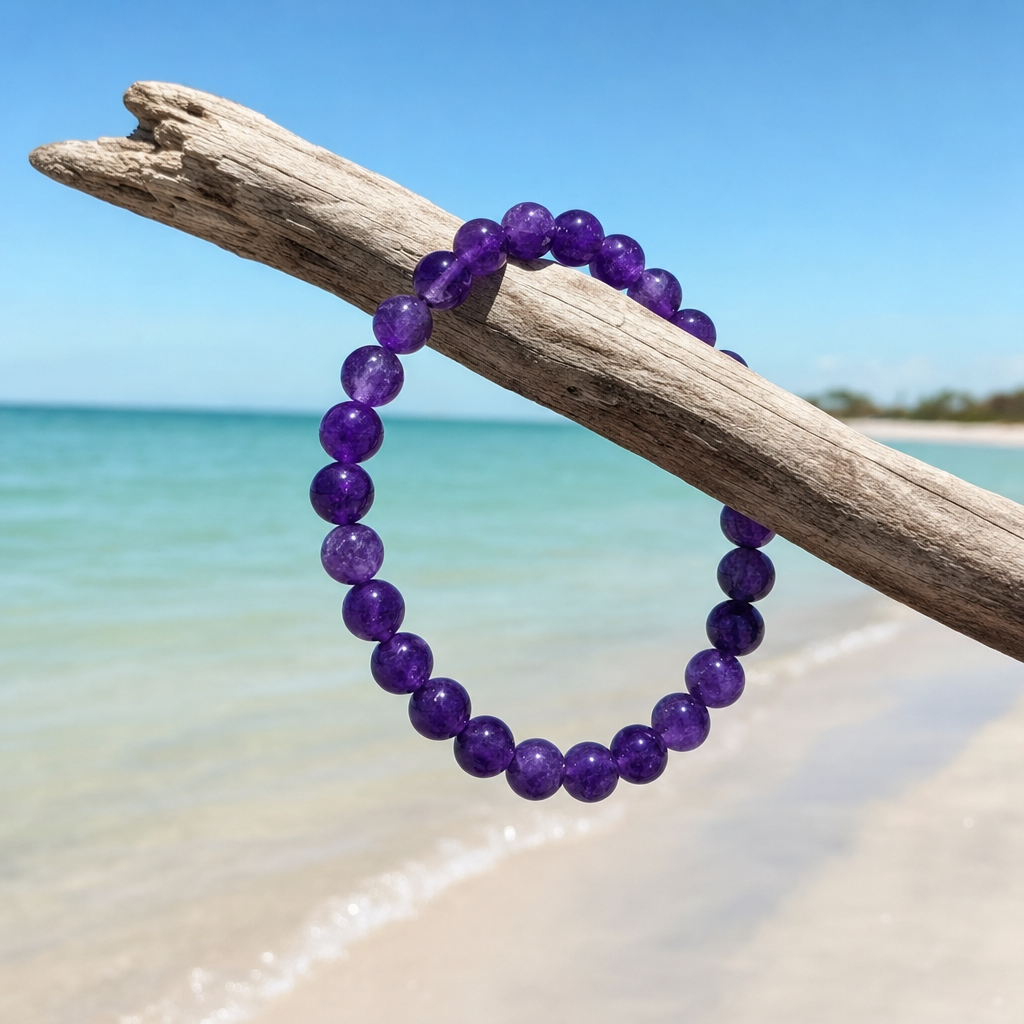 Amethyst gemstone beaded stretch bracelet with deep purple 8mm natural amethyst beads on Florida Gulf Coast beach &mdash; Crabby Mermaid